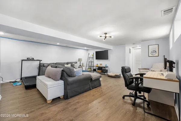 a living room with furniture and a wooden floor