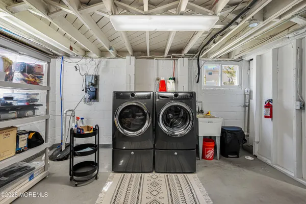 a utility room with dryer washer and other items