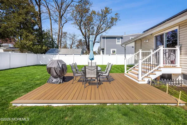 a view of a house with backyard and sitting area