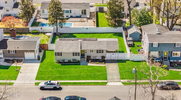 a view of a chairs and table in the back yard of the house