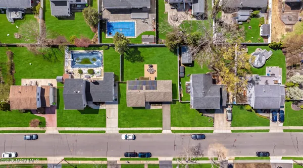 an aerial view of multiple houses with a yard