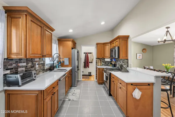 a kitchen with stainless steel appliances a sink stove and cabinets