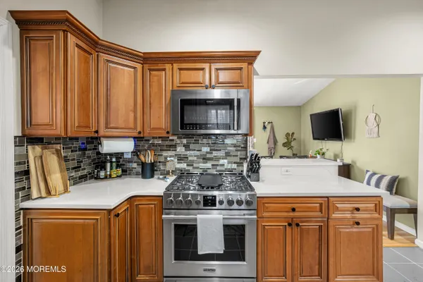 a kitchen with stainless steel appliances a stove a microwave sink and cabinets