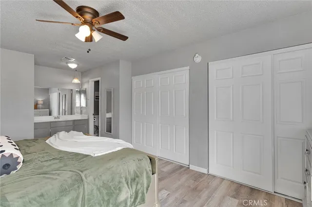 a spacious bedroom with a bed and a chandelier