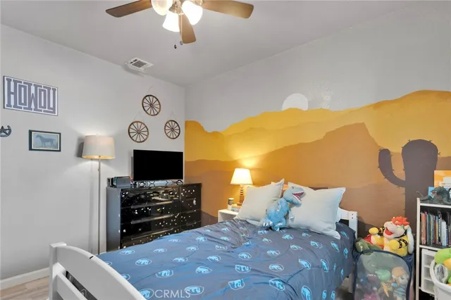 a bed room with a bed and a television