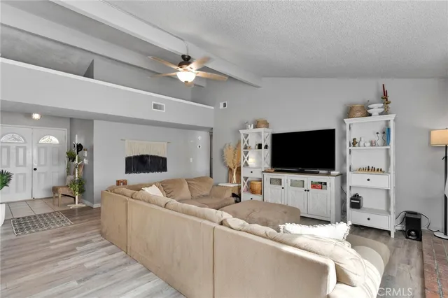 a view of a livingroom with furniture and a flat screen tv