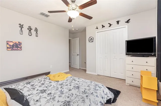 a bedroom with a bed and flat screen tv