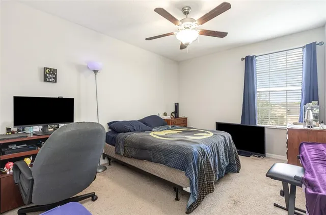 a bedroom with a bed and a window