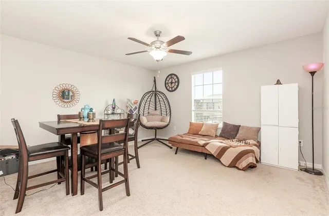 a living room with furniture a clock and a window