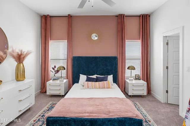 a bedroom with a bed and a flat tv screen on dresser