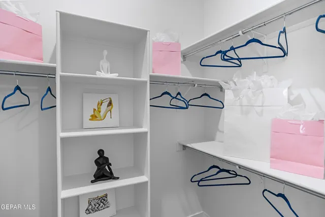 a view of storage and utility room with clothes and shoes