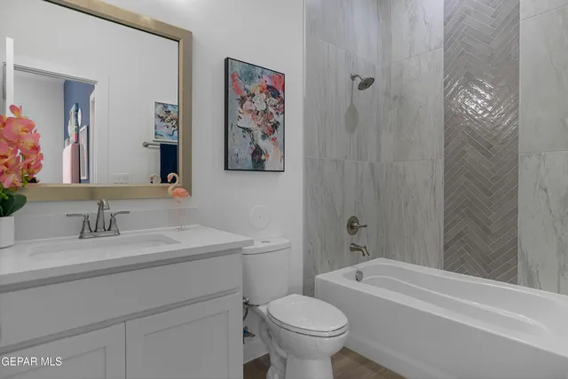 a bathroom with a painting on the wall