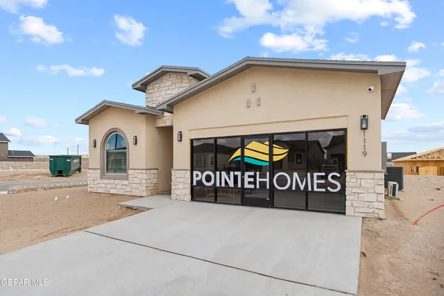 a view of a brick house with large windows