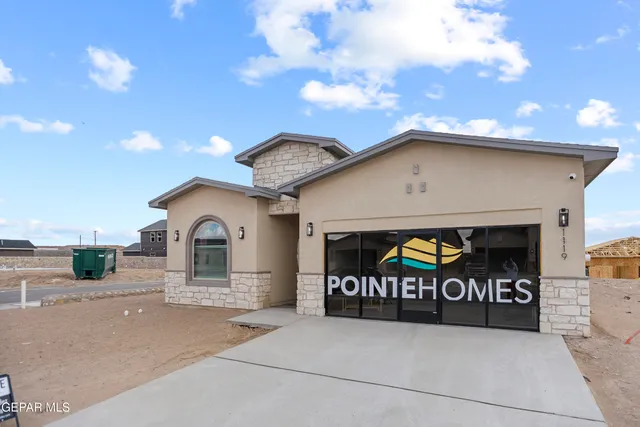 a front view of a house with garage