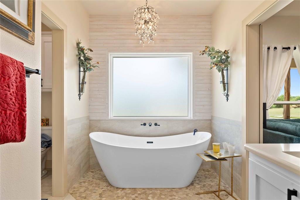 1010 Fm 583 Street West Rising Star, TX 76471 - Photo 27 of 40 a white bath tub sitting in a bathroom next to a window