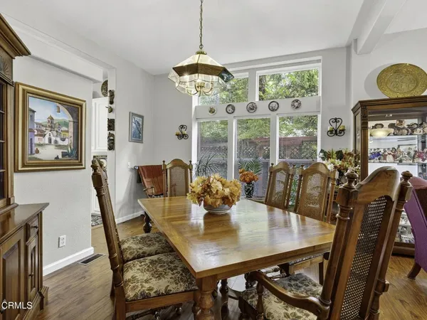 a view of a dining room with furniture window and wooden floor