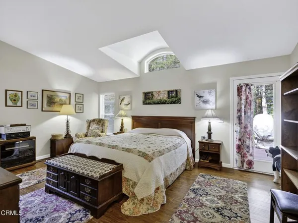 a bedroom with a bed mirror and window