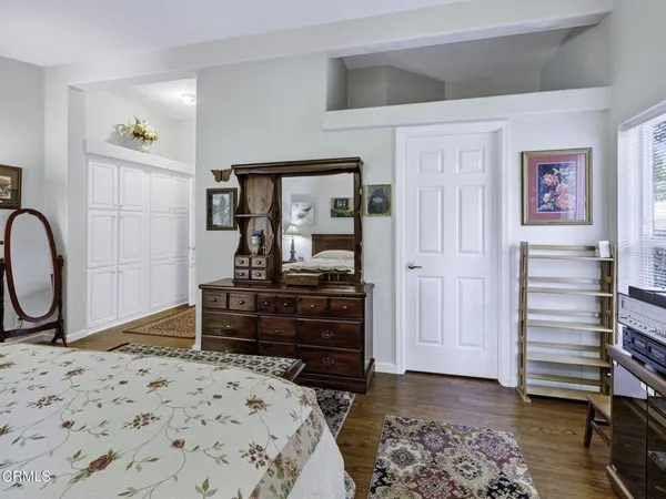 a bedroom with a bed and a dresser in it