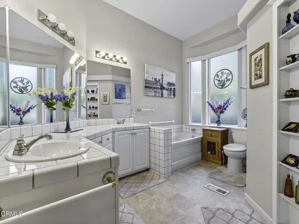 a bathroom with a sink a vanity and a mirror