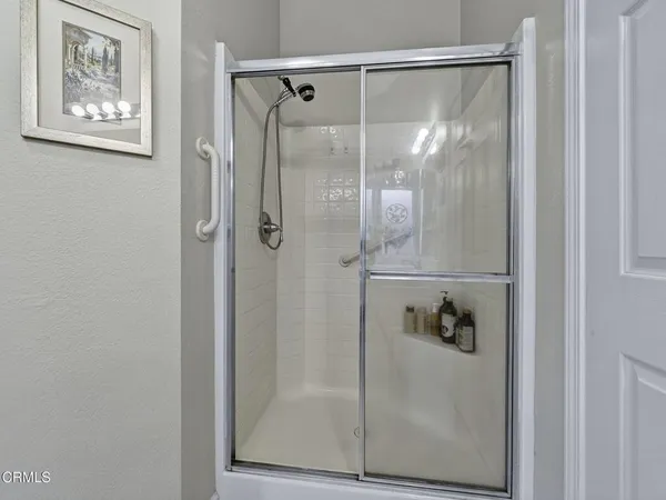 a bathroom with a glass shower door