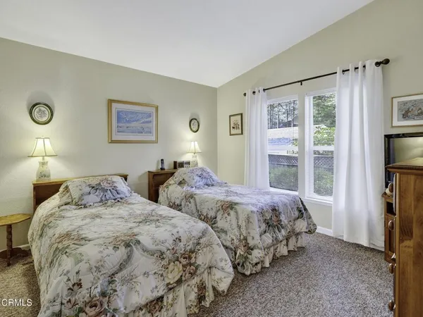 a bedroom with two beds and a window