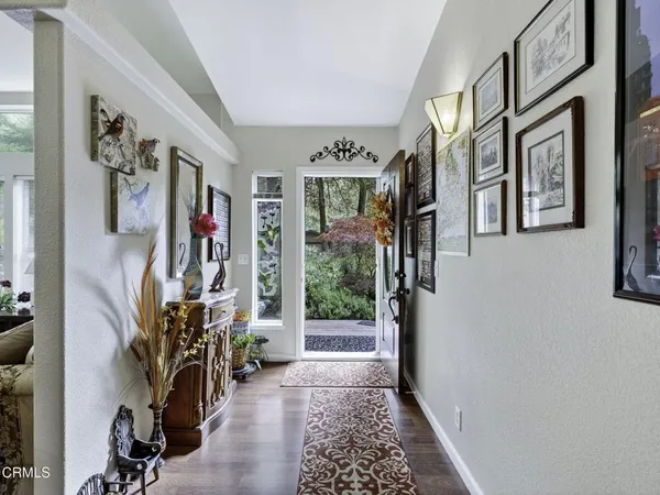 a view of an entryway with wooden floor