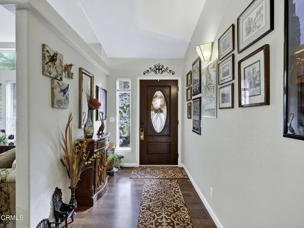 a view of an entryway with wooden floor