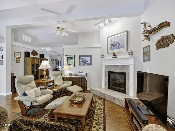 a living room with furniture fireplace and a table