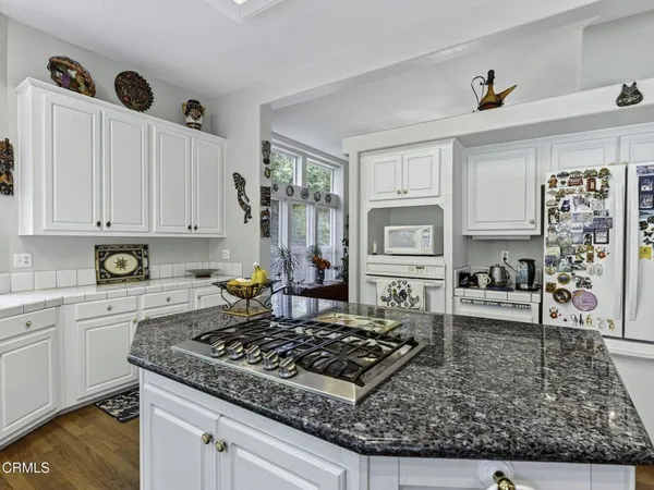a kitchen with sink stove and cabinets