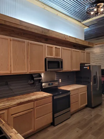 a kitchen with stainless steel appliances granite countertop a sink and a stove