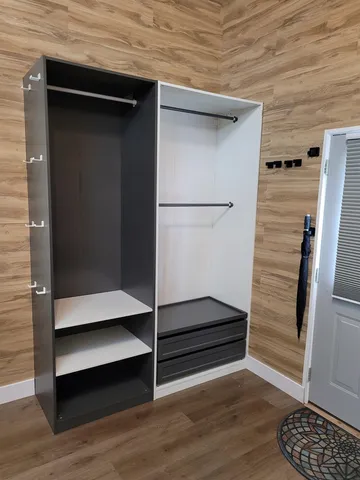 a view of walk in closet with clothes and shoes