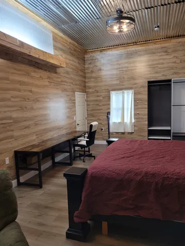 a bedroom with furniture and a window