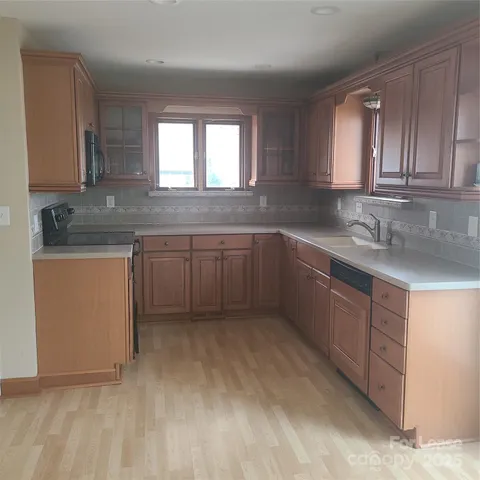 a kitchen with a sink cabinets and window