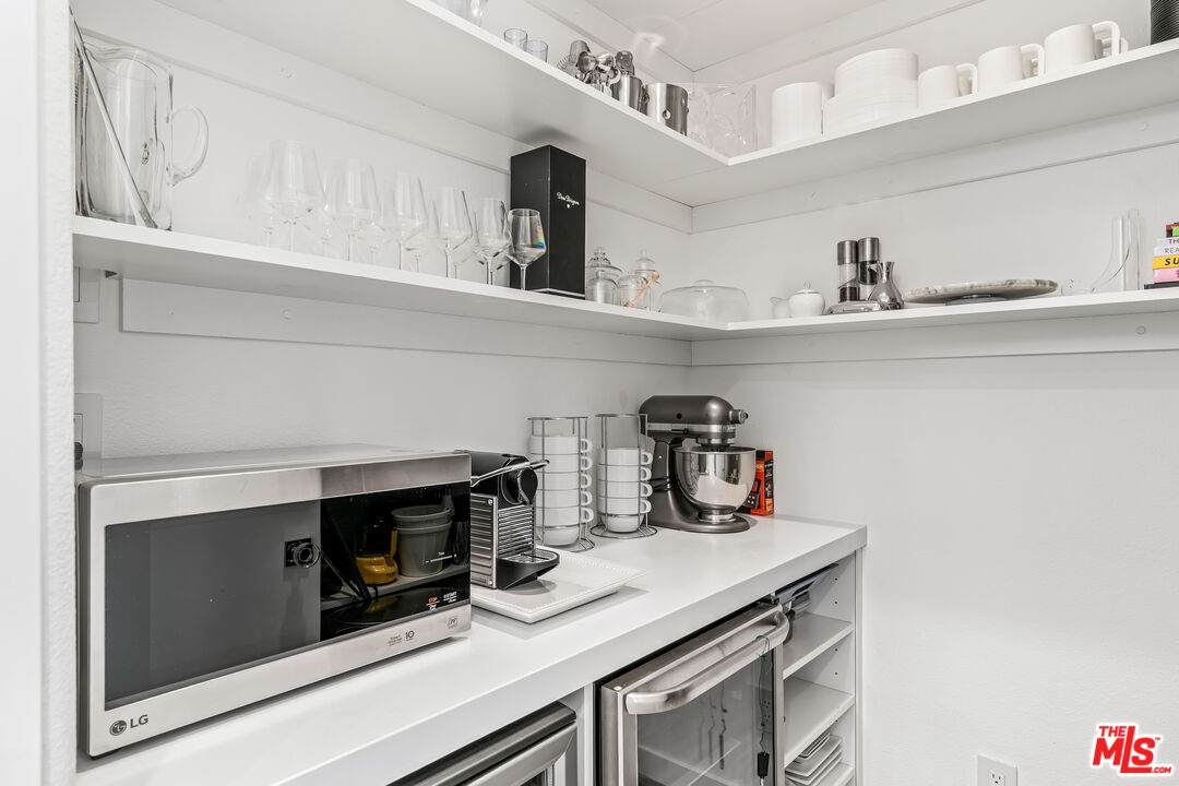 2788 Princess Lane Palm Springs, CA 92264 - Photo 20 of 67 a kitchen with a sink dishwasher a stove and a microwave with cabinets