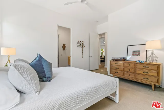 a spacious bedroom with a bed and wooden floor