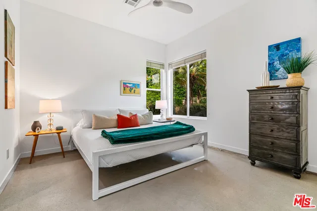 a bathroom with double vanity sinks a large mirror and a bathtub
