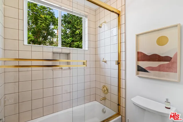 a view of a patio with a table chairs and a small yard