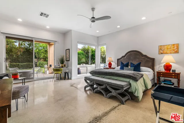 a view of a house with a backyard patio and a garden