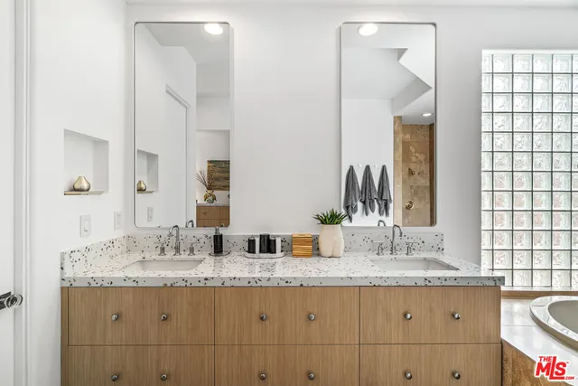 a front view of a house with a yard and potted plants