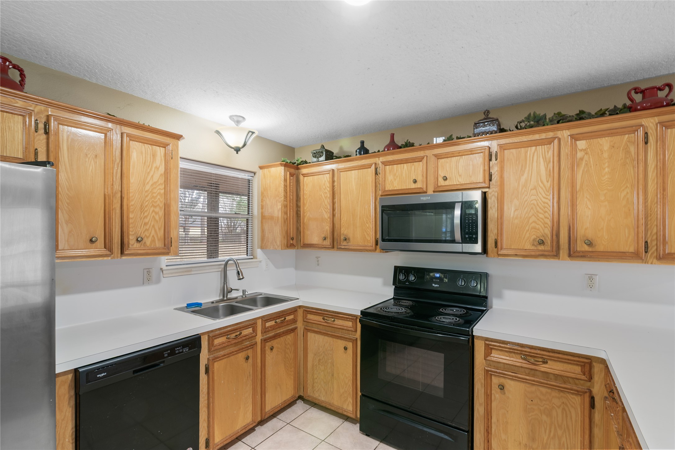 18914 Hamish Road Tomball, TX 77377 - Photo 19 of 39 a kitchen with stainless steel appliances granite countertop a stove microwave and sink
