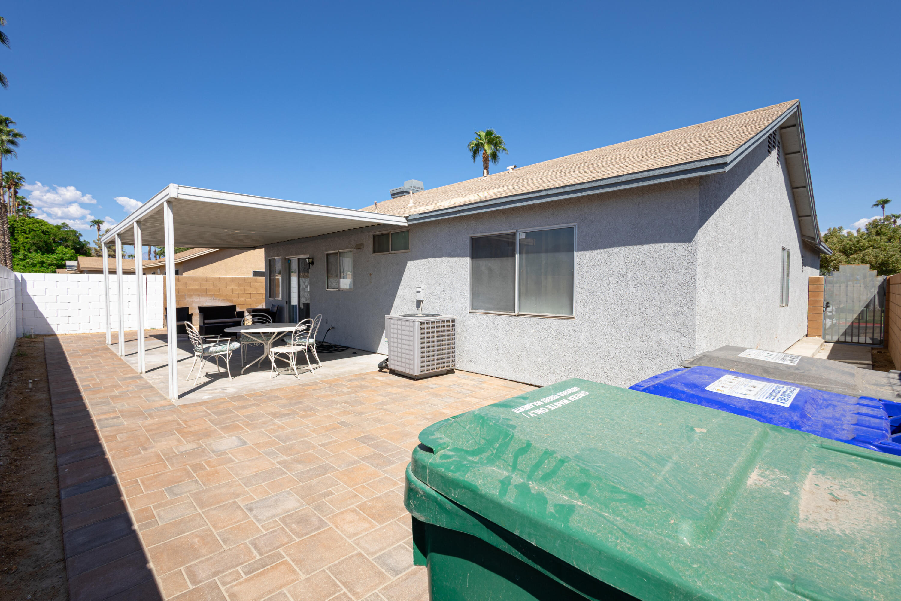 47800 Madison Street, Unit 37 Indio, CA 92201 - Photo 14 of 15 a view of a patio with a table and chairs under an umbrella