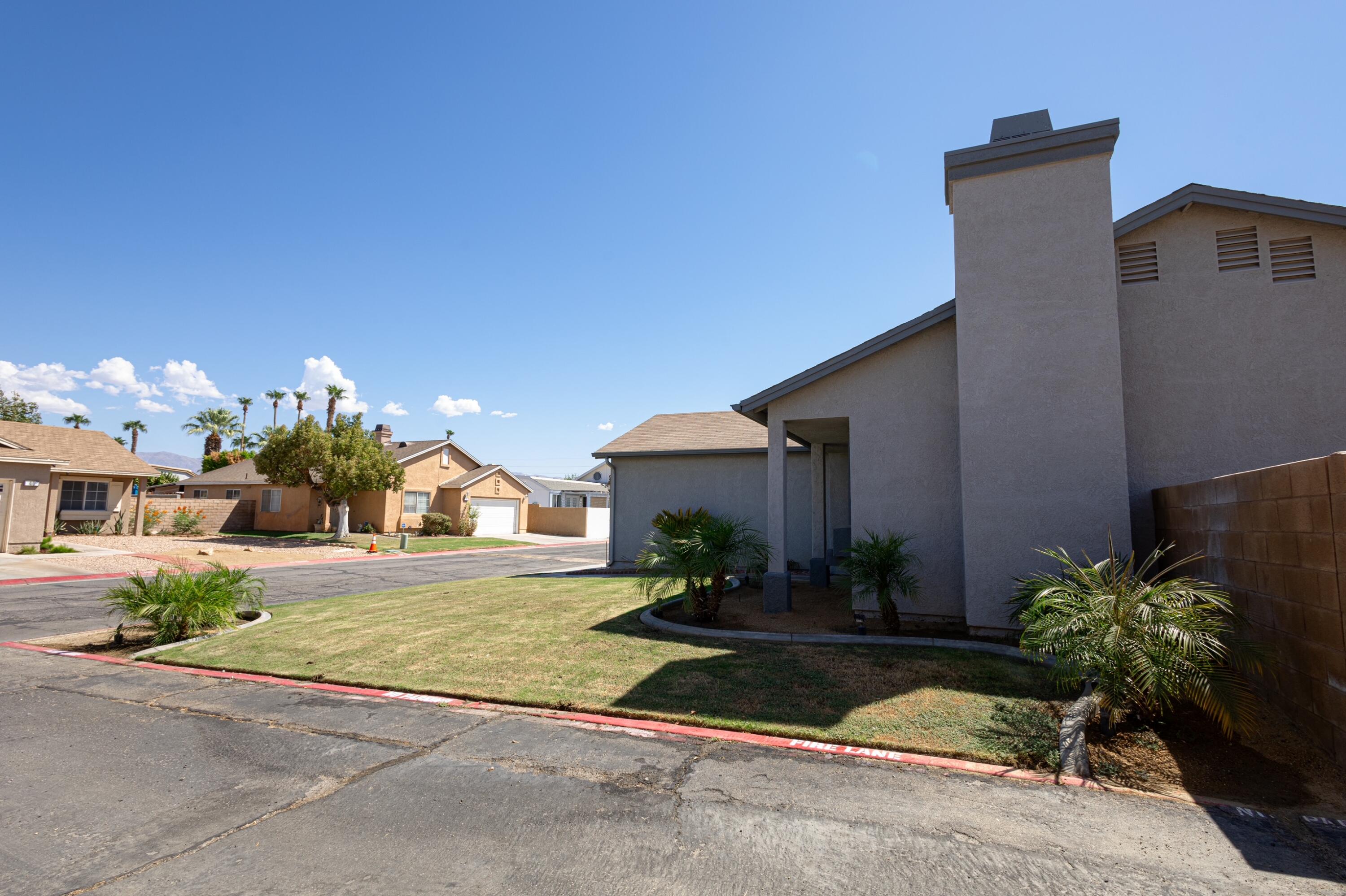 47800 Madison Street, Unit 37 Indio, CA 92201 - Photo 3 of 15 a front view of a house with garden