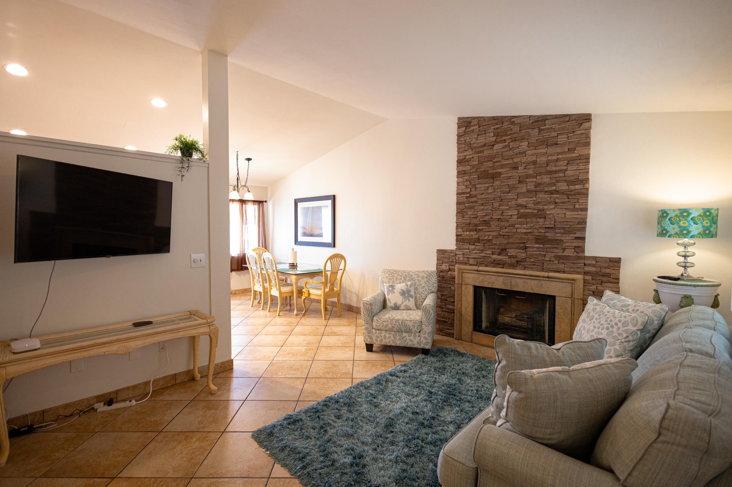 47800 Madison Street, Unit 37 Indio, CA 92201 - Photo 5 of 15 a living room with furniture and a flat screen tv