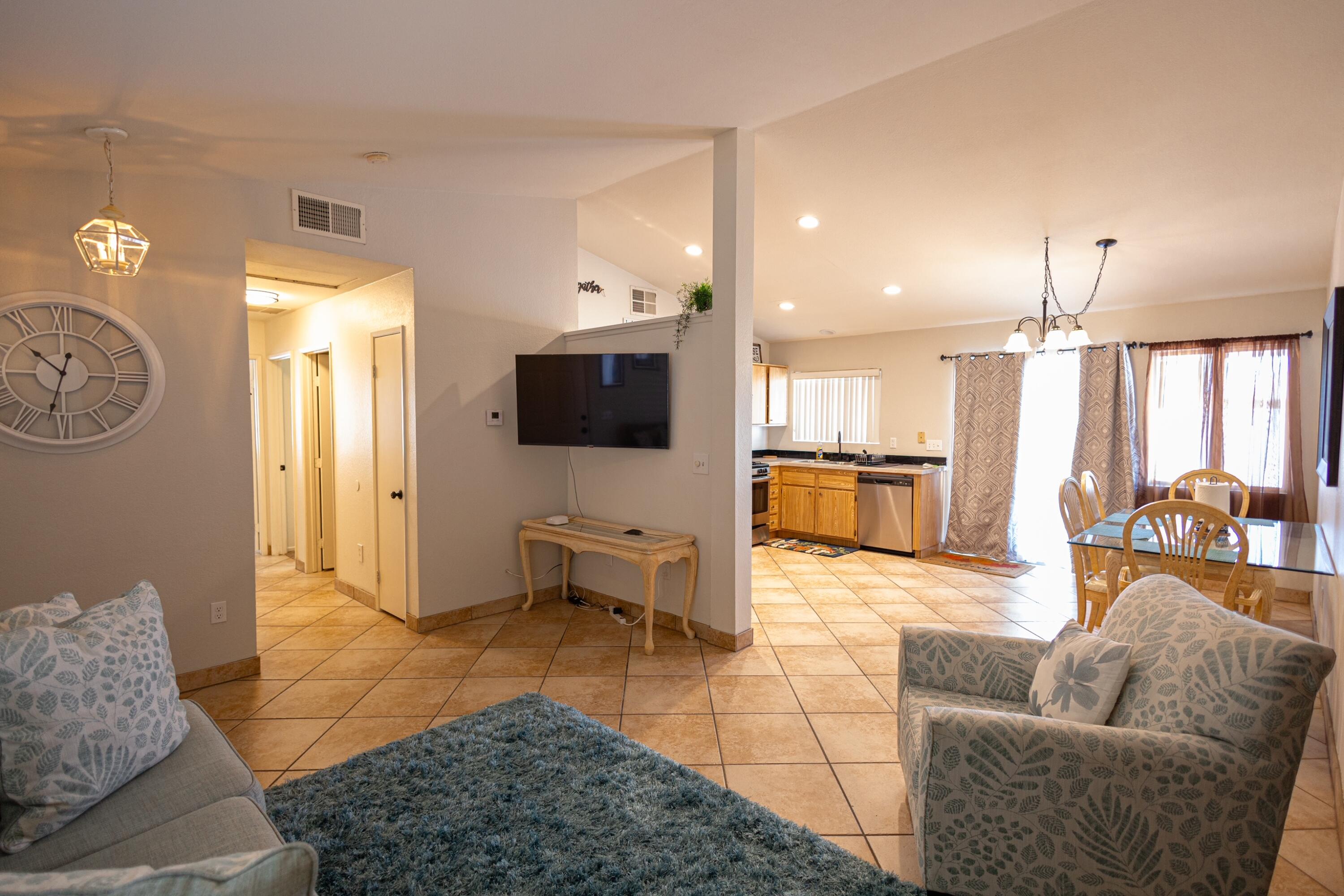 47800 Madison Street, Unit 37 Indio, CA 92201 - Photo 8 of 15 a living room with furniture and a flat screen tv