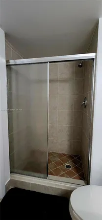 a bathroom with a shower and a toilet