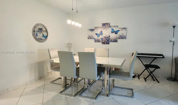 a view of a dining room with furniture and a chandelier