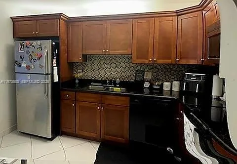 a kitchen with a refrigerator and cabinets
