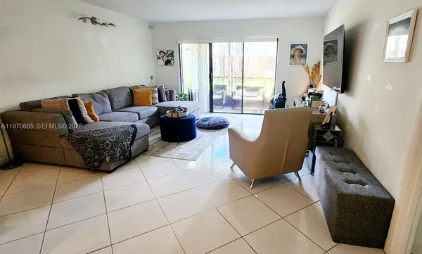 a living room with furniture and a floor to ceiling window