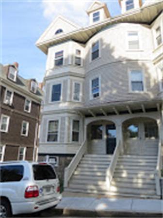 11 Hurd Road, Unit 2 Brookline, MA 02445 - Photo 1 of 18 a front view of a house with yard