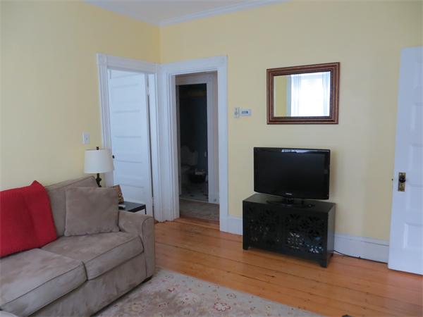 11 Hurd Road, Unit 2 Brookline, MA 02445 - Photo 4 of 18 a living room with furniture and a flat screen tv